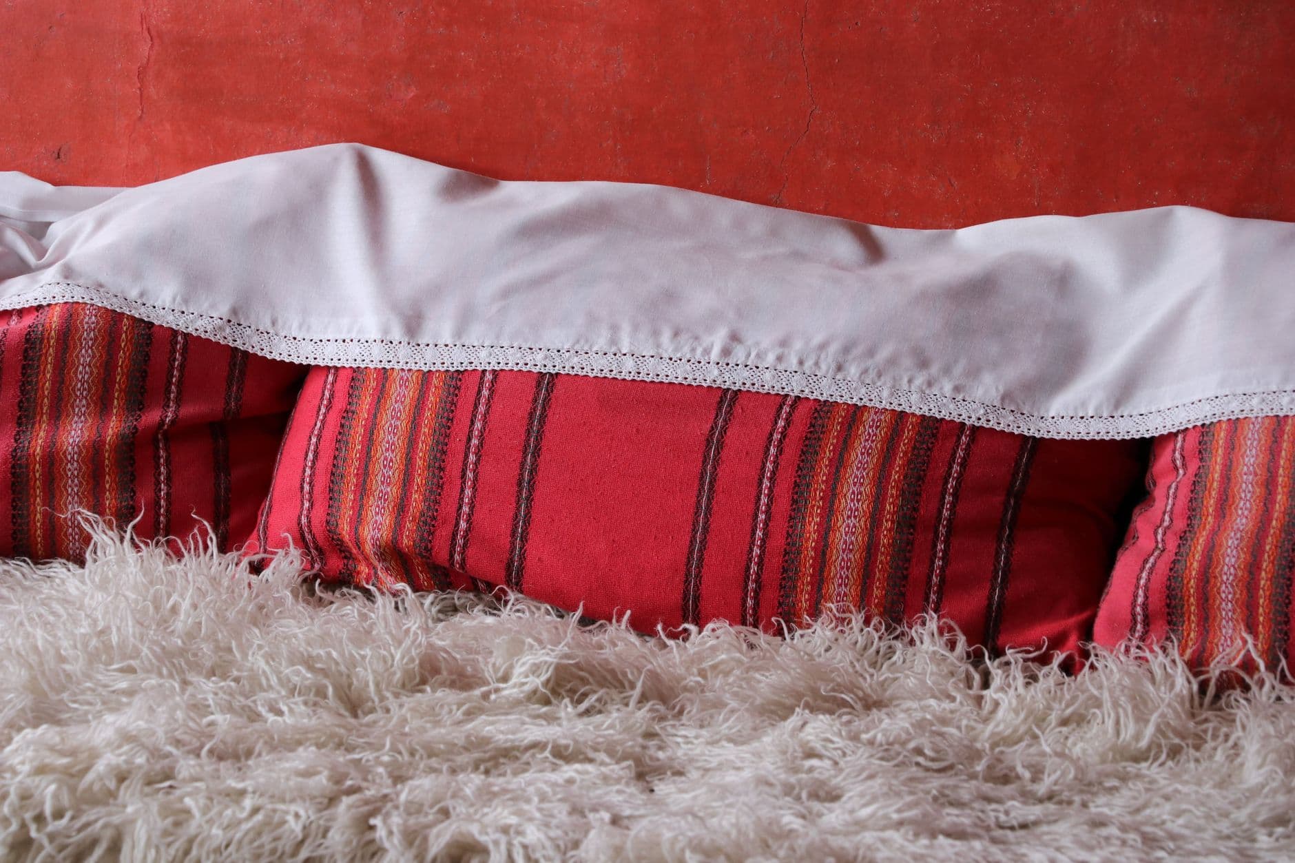 Bash – Layering textures and throws: boutique-hotel bed styling secrets